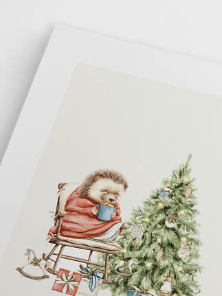 Illustration af sovende pindsvin i gyngestol med rød plaid ved pyntet juletræ