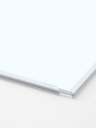 Close-up of square mirror with white frame and subtle MOEBE logo