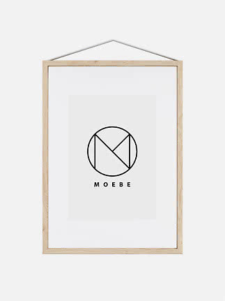 Light wood frame with white mat and MOEBE logo, hanging from a cord