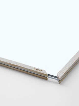 Close-up of light wood frame with transparent front and corner detail