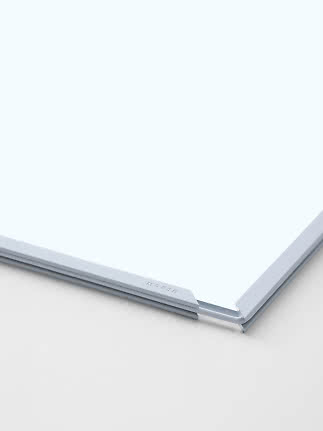 Close-up of white board with aluminum frame and corner bracket