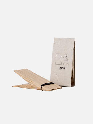 Moebe Pinch in oak with two wooden panels held by a black band, shown with packaging