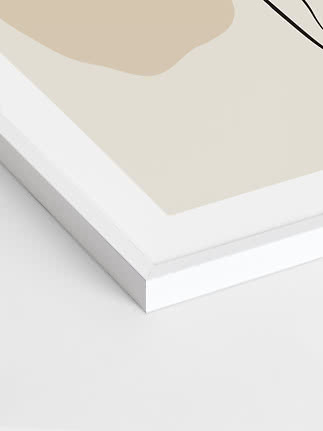 Close-up of abstract art print in white frame with beige shapes and black lines