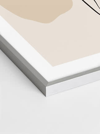 Close-up of framed abstract print with beige shapes and black line on white background