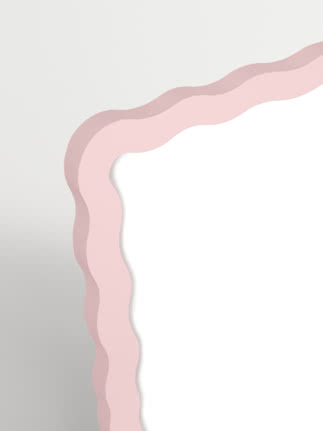 Wavy mirror with pink frame against a white background