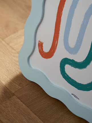 Close-up of art print with wavy light blue border and abstract brushstrokes in orange, blue and green