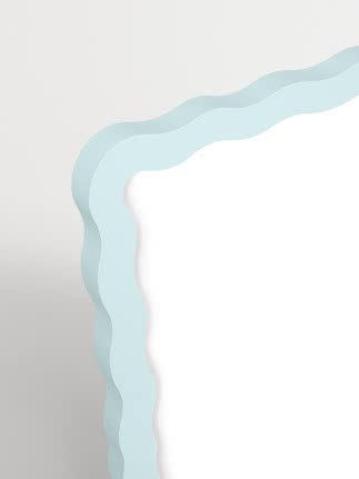 Mirror with light blue wavy frame on white background