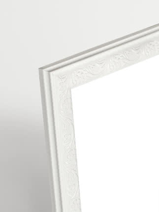 Close-up of white Versailles picture frame with decorative floral pattern