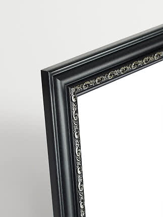Close-up of black picture frame with silver decorative inner edge