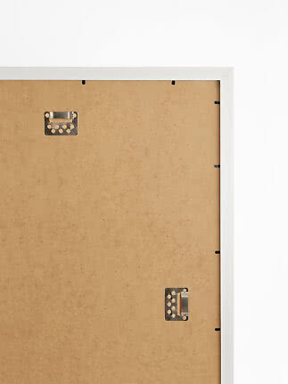 Back of white and silver picture frame with hanging brackets and MDF backing