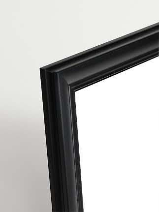 Close-up of black picture frame with profiled edge on a light background