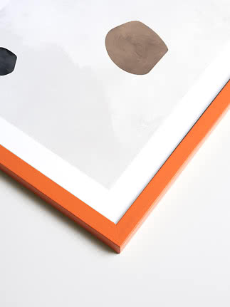 Abstract art print with white mat, orange frame, and simple black and beige shapes