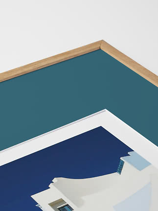 Close-up of framed art print with oak frame and blue architectural detail
