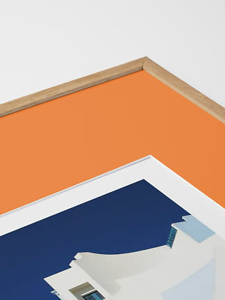 Close-up of framed print with orange background and white building