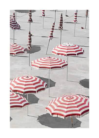 Red and white striped parasols on a pale concrete surface, some open and some closed