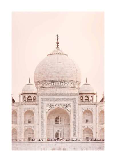Front view of the Taj Mahal’s white marble dome and facade against a soft pink sky