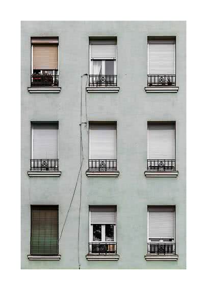 Apartment facade with nine windows, shutters, and small black balcony railings