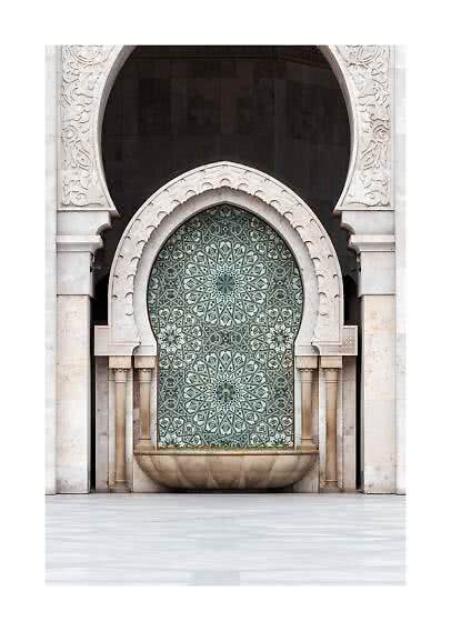 Ornate stone wall with arched niche, mosaic pattern, and Moorish-style fountain