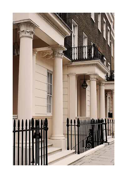 Classic townhouse facade with cream columns, black railings and balconies