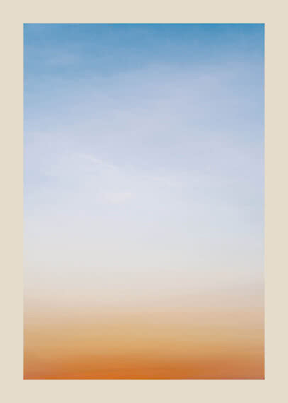 Blauer Himmel mit feinen Wolken und warmem orangefarbenem Schimmer am Horizont