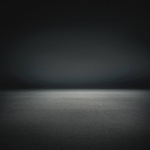 Una parete scura che sfuma verso il nero sopra un pavimento chiaro, unite in una morbida banda di luce senza bordi