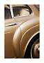 Close-up of rear door and wheel arch on a gold vintage car with chrome trim
