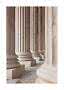Row of fluted marble columns in light beige and gray tones