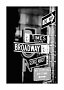 Black-and-white photo of street signs at Broadway and Times Square in New York