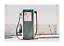 Vintage green gas pump with hose in front of a worn white wall