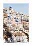 White houses with blue domes on a sunny Santorini hillside under a clear blue sky