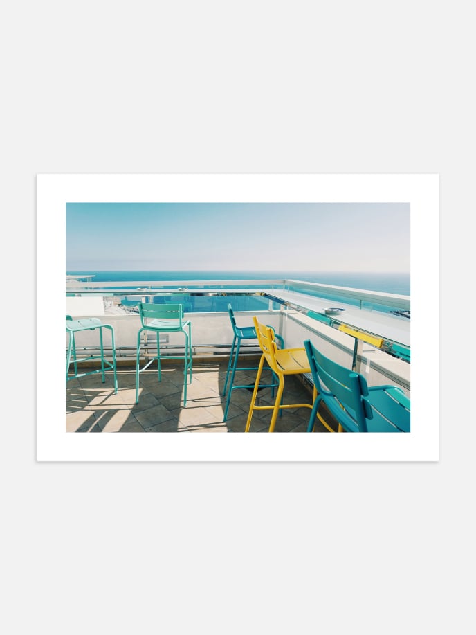 Colorful Chairs by the Sea Poster